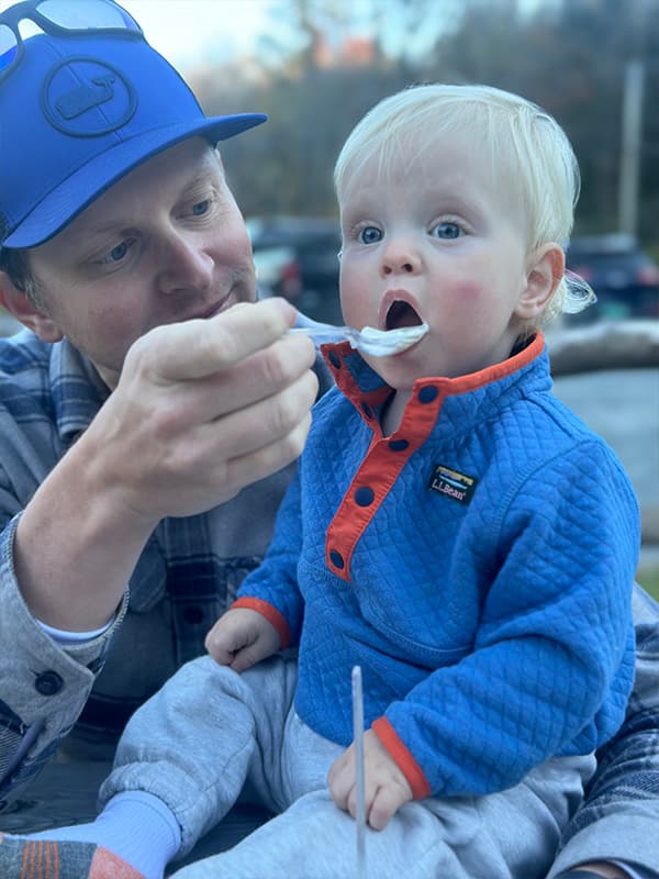 Brian feeding his young son