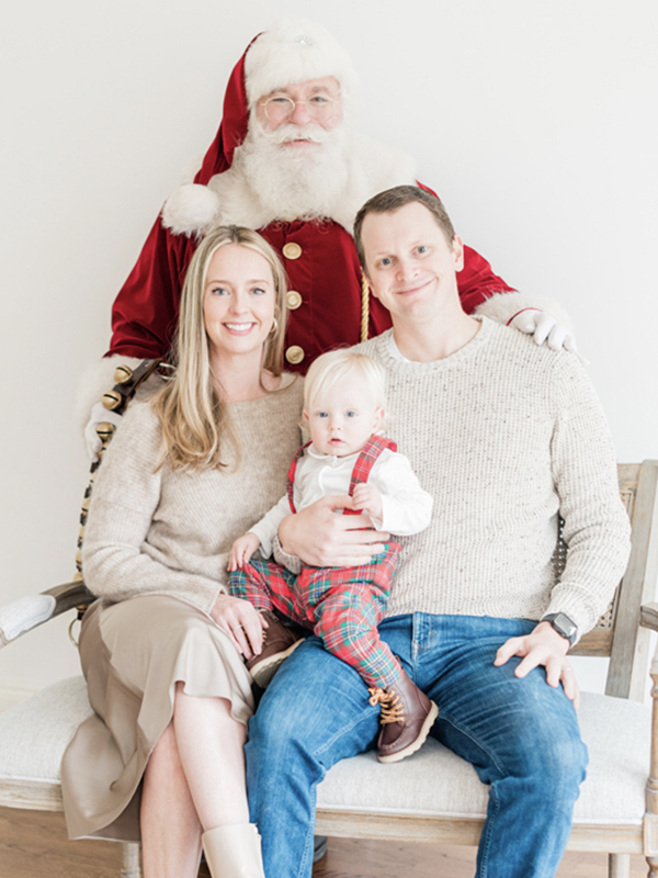 Brian with his wife and their son as a toddler with Santa