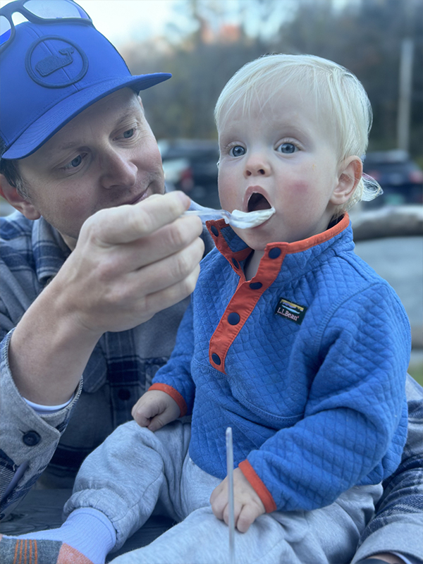 Brian feeding his young son